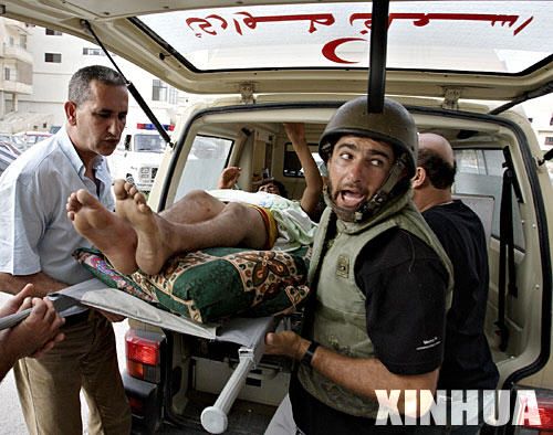 图文：医疗人员将在空袭中受伤的男孩送进医院