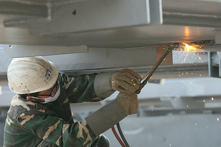 图文：鸟巢实施钢结构卸载 现场工人进行焊接