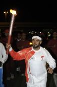 图文：奥运火炬手库姆扎里手持火炬传递