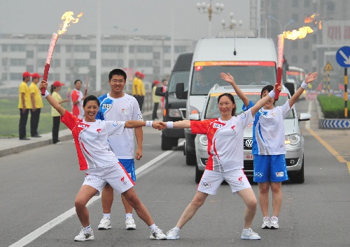 图文圣火临沂传递王军英与任瑞萍交接后庆祝