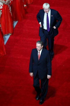 图为国际奥运会主席罗格(前者)和约翰逊在北京奥运闭幕式上