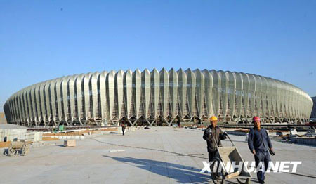 11月27日，工人在可容纳6万人的济南奥体中心主体育场外施工。