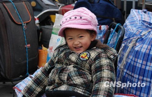 2月6日，江苏镇江长途汽车站里跟随父母返乡的孩子们纯真灿烂的笑脸令人印象深刻。中新社发 封波 摄