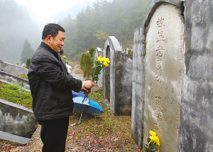 酉阳县凤凰山公墓,一位居民改用鲜花来祭祀.