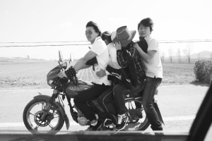 5月27日,锦州北镇医巫闾山下的公路上,一辆摩托车上挤了四个人,摩托车