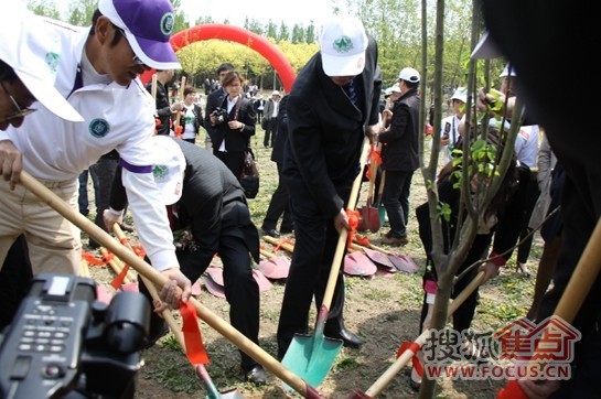 陈道明与总裁佘学彬为大自然地板奥林匹克生态林挥锹培土，植下一棵爱心树。