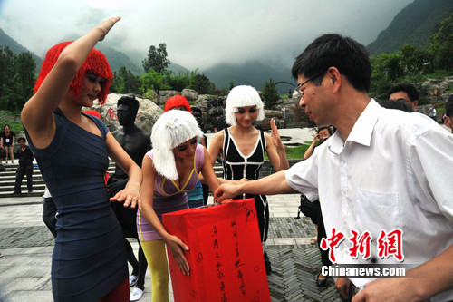 6月19日，美丽模特在江西宜春明月山景区秀“行为艺术”，并向现场游客和市民进行公益募捐。