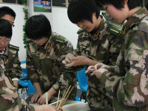 1月1日,中国人民武装警察部队学院的几名学员在食堂包饺子,欢庆元旦节