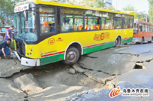 乌鲁木齐:自来水管老化爆裂致路面塌大坑 陷住公交车