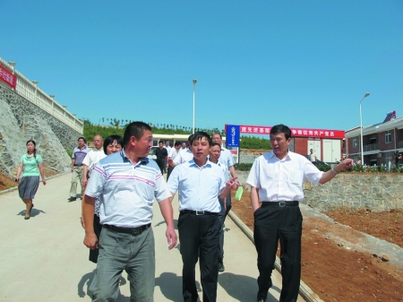 省政府移民办副主任王小平(右)在辉县市常村镇沿江移民新村调研