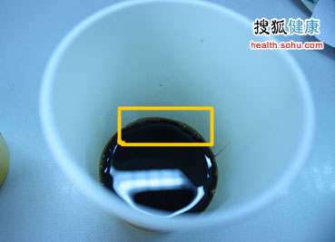 倒在杯子里的酿制醋，杯子边缘仍可见泡沫