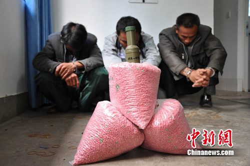 图为抓获的犯罪嫌疑人，缴获的冰毒和手榴弹。摄影：赵家碧