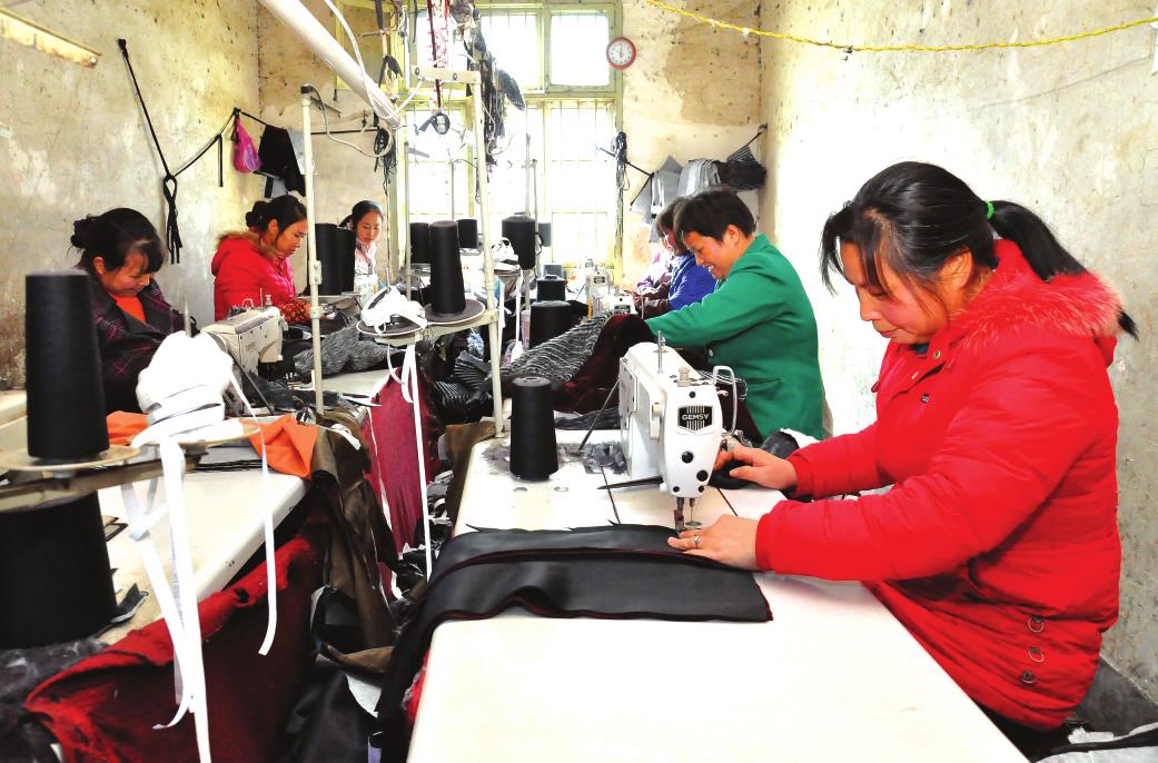 12月11日,新邵县陈家坊镇长江村妇女在服装厂