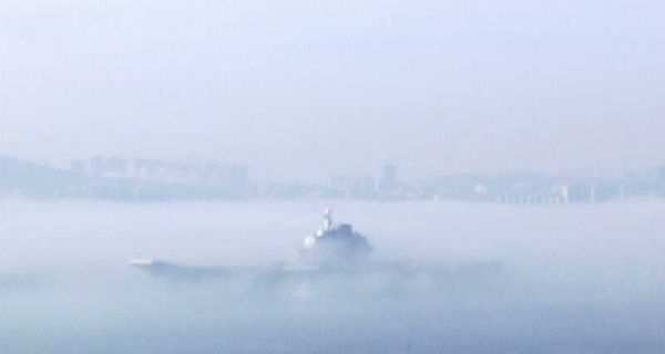 中国航母平台雾霭中返回大连港。