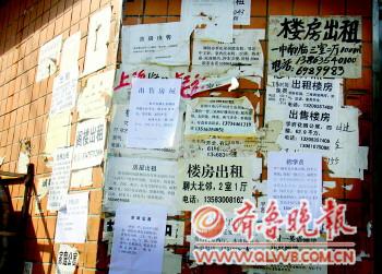 文轩中学附近的墙上贴满了租房的小广告. 本报记者 邹俊美 摄