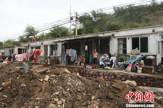 北京市西南部的房山区青龙湖镇北车营村，是7月21日大暴雨的重灾区。23日傍晚，蔚蓝的晴空下，处于葱翠两山间的村庄却一片狼藉。 陈思颖 摄