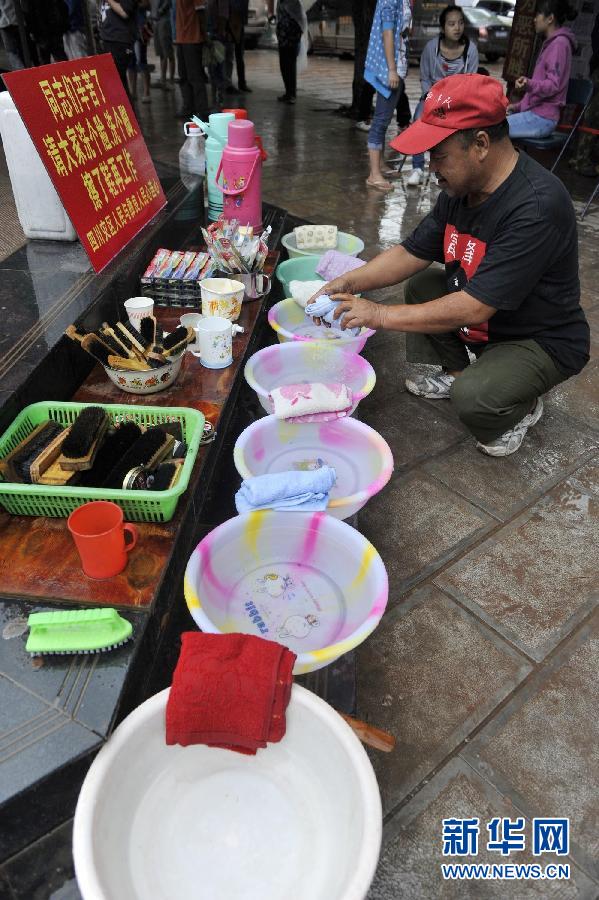 9月12日，刘光建在摆放脸盆、帕子，给过往的群众提供方便。