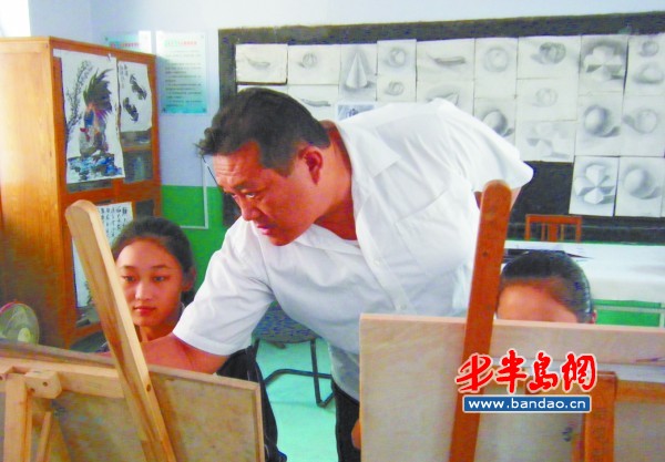 崔宪波正在指导学生画画.