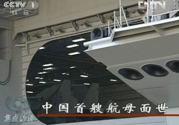 9月25日《焦点访谈》节目截图，可以看到中国首艘航母机库内停放着数目未知的舰载机。