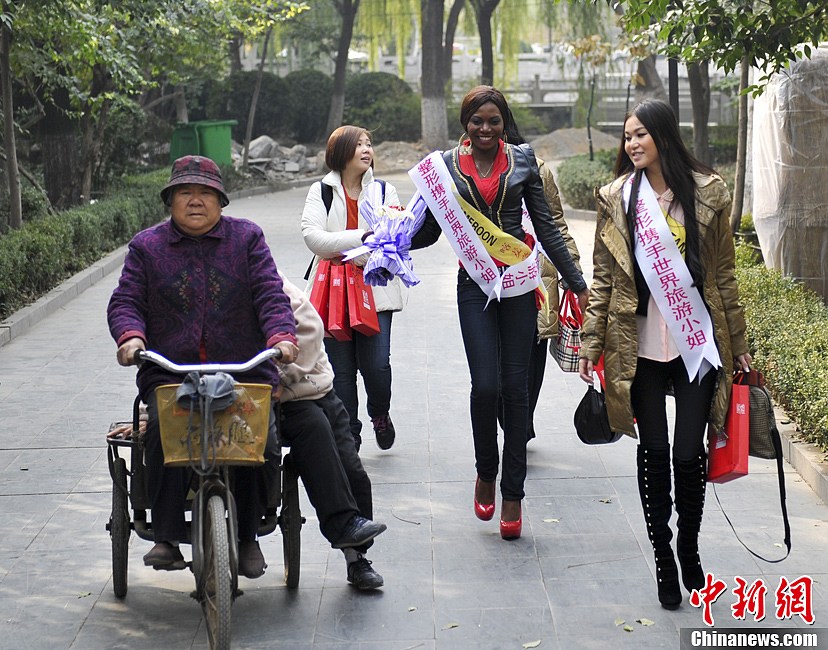11月21日，参加2012年度世界旅游小姐全球总决赛佳丽巡游泉城济南，展示异国美丽。图为佳丽大跳“骑马舞”。中新社发 张勇