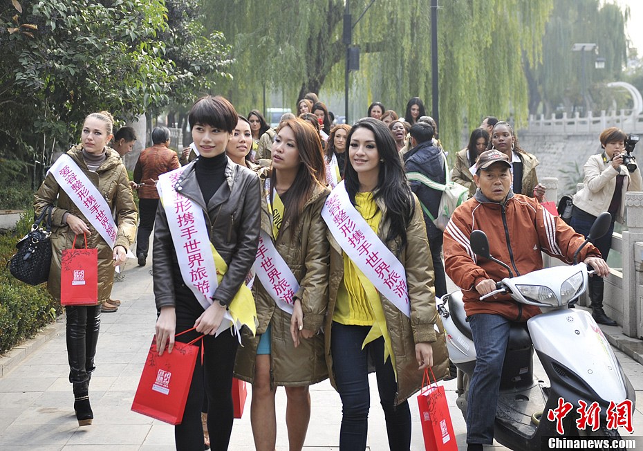 11月21日，参加2012年度世界旅游小姐全球总决赛佳丽巡游泉城济南，展示异国美丽。图为佳丽大跳“骑马舞”。中新社发 张勇