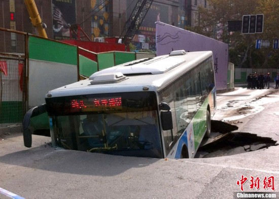 陷,一辆31路公交车经过时轮子被陷住,半个车身陷入,没造成人员高清图片
