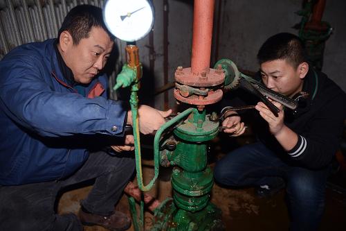 12月16日,长春市供热集团东泰分公司供暖抢修员在东泰换热站地下室