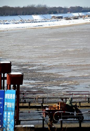 12月25日，在黄河山东济南段，河面出现流凌，沿岸有积冰。新华社记者 徐速绘 摄