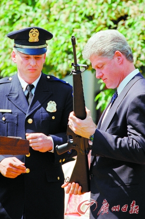 前总统克林顿正在把玩枪支。
