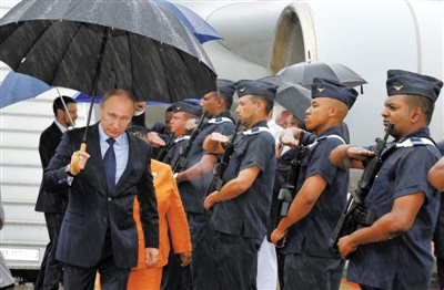 26日，俄罗斯总统普京抵达德班国际机场，撑伞走下专机。