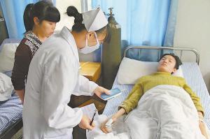 护士正在为彭健检查身体。本报记者 邹海斌摄