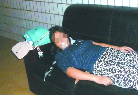 女子横躺在沙发上口吐白沫　通讯员 康睿 记者 吴珊 摄