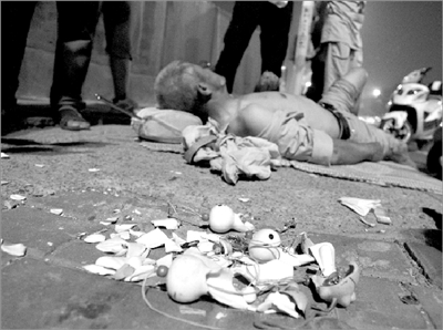 受伤老人躺倒在地上，商品散落一地。京华时报记者 谭青 摄