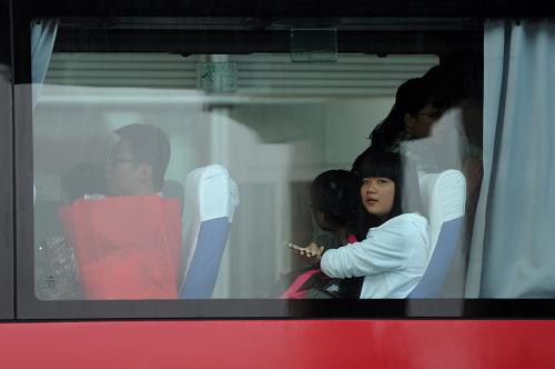 7月13日，在北京首都国际机场，师生们登上大巴车。新华社记者 罗晓光 摄