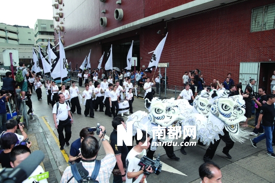 昨晨出殡仪式上，由三只孝狮带领出殡队伍缓缓离去。