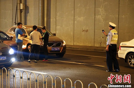 9月18日，北京迎来中秋节前晚高峰，西直门附近行驶的两辆车发生摩擦。中新社发 刘关关 摄