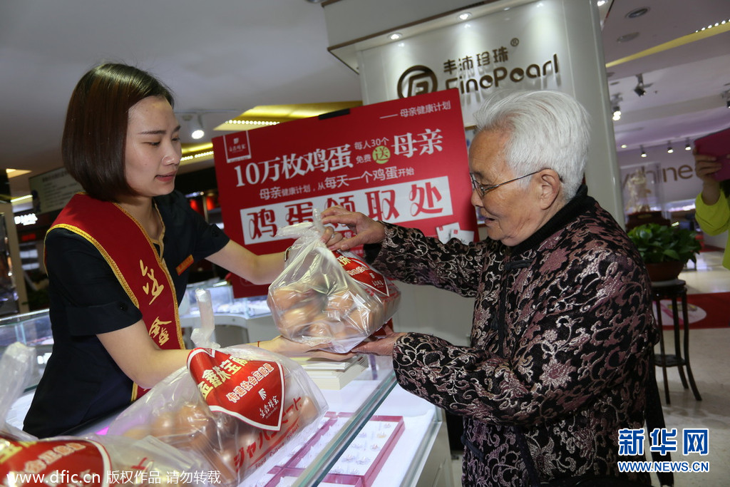 2014年5月10日，河南省郑州市，二七路金鑫珠宝店门口，市民排起了数十米长队等待免费取鸡蛋。