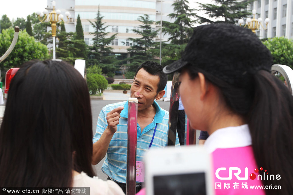 2014年06月08日，山东省济南市一名考生因为迟到被禁止进入考场，不少家长现场求情未果，考生只能带着遗憾离开。图为现场家长和记者为考生求情。
