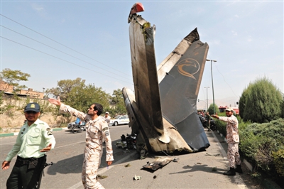 10日，伊朗首都德黑兰，伊朗革命卫队成员和安全人员聚集在失事飞机残骸附近。当日，一架小型客机坠毁，造成39人遇难。新华社发