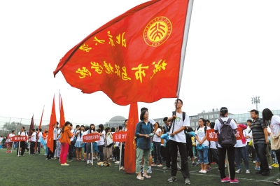 北大开学典礼上，学生们挥舞学院旗帜。京华时报记者徐晓帆摄