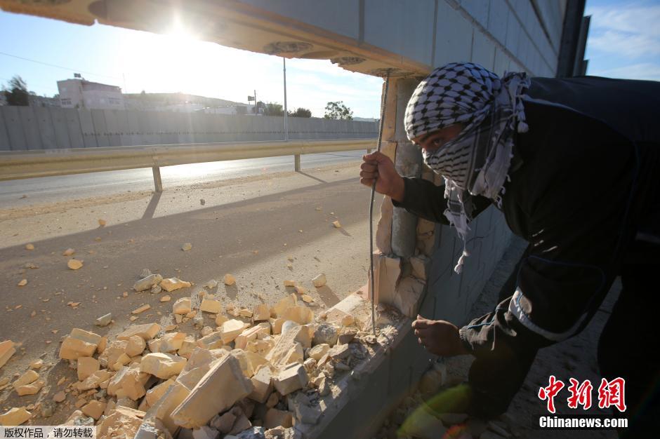 巴勒斯坦青年凿穿以色列隔离墙 纪念柏林墙倒