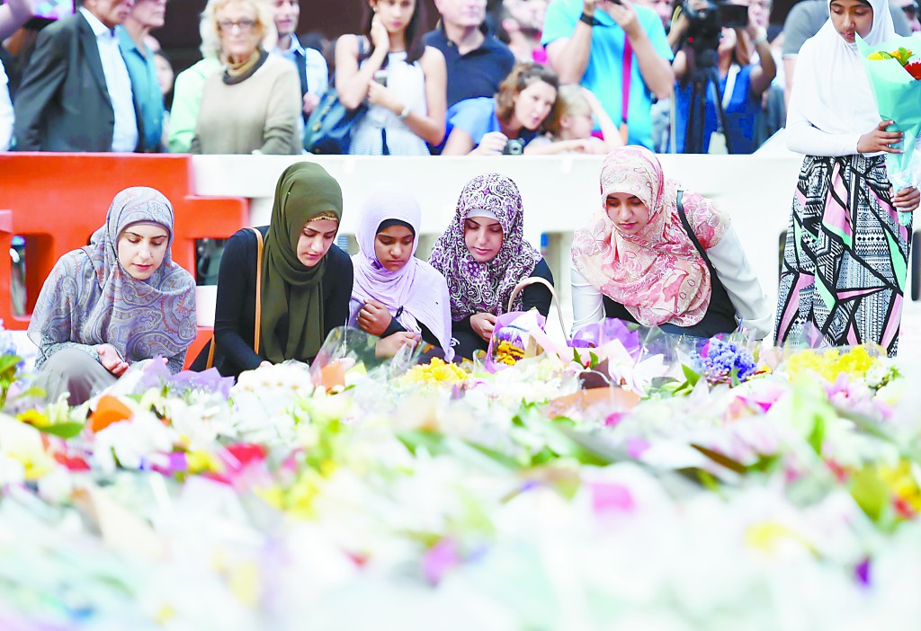 16日，悉尼穆斯林妇女在劫持事件案发地献上鲜花。