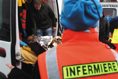 12月28日，在意大利的拉韦纳港，一名获救船员被抬上救护车。