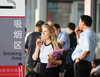 旅客在北京首都机场t3航站楼外专设的吸烟区吸烟.