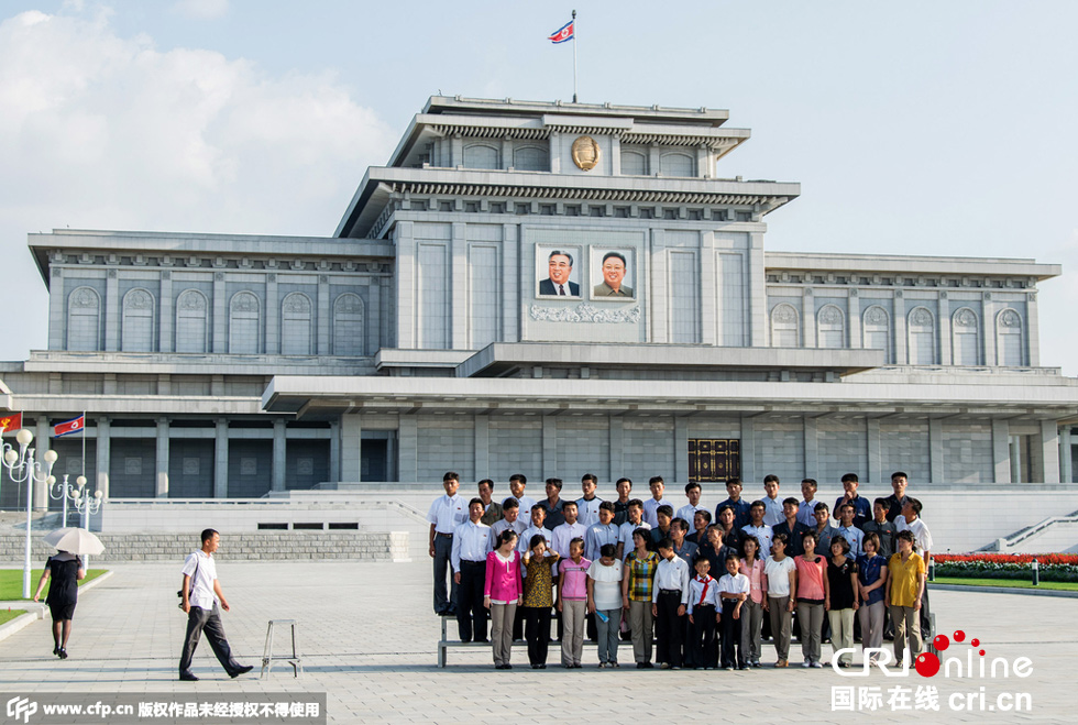 当地时间2015年8月21日,朝鲜咸兴,一名男孩在站台上乞讨.