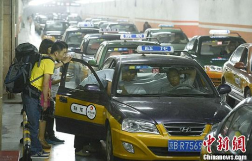 資料圖：市民在北京西客站出租車候車點準備乘車。中新社發 侯宇 攝