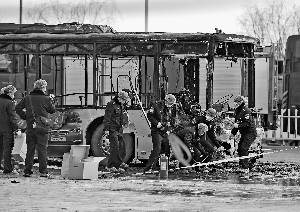 5日,警察在公交车起火事故现场勘察。公交车被烧只剩下一个铁架子。新华社发