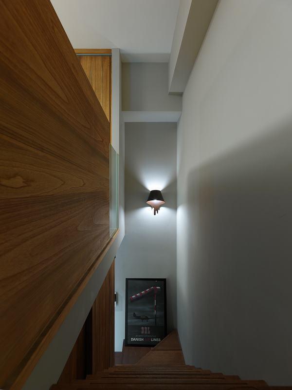 木质的楼梯,配上壁灯,在中间段墙角未免单调用照片来装饰,自上而下看