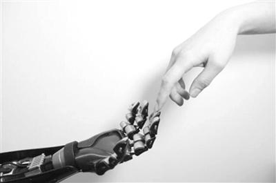 (图)人类的手指在触碰机器人手指,这项研究的目标是开发一种嵌满微型