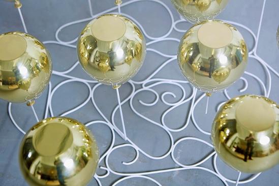 好生活介绍过 Duffy London 的创始人克里斯托弗·达菲（Christopher Duffy）在2012年设计的悬漂咖啡桌，彼时的长方形咖啡桌在时隔三年后的如今摇身变成圆形、并新增加红色气球的款式，组成2015版系列重现江湖 。杂乱有章的钢筋绳、金属与树脂复合气球 、以及钢化玻璃台面共同造就了奇妙的错视感 。气球颜色有金、银、红三色，也可混合搭配，但起价8300美元，限量25张。